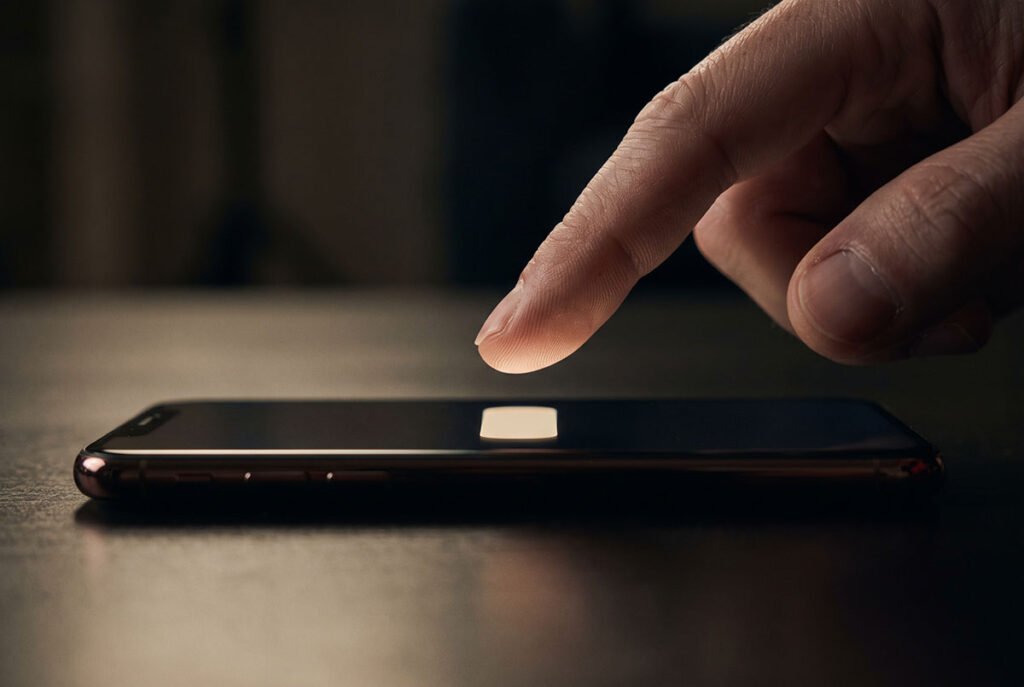 A fingertip hovers above a glowing phone button without pressing it, visualizing hesitation before purchase.