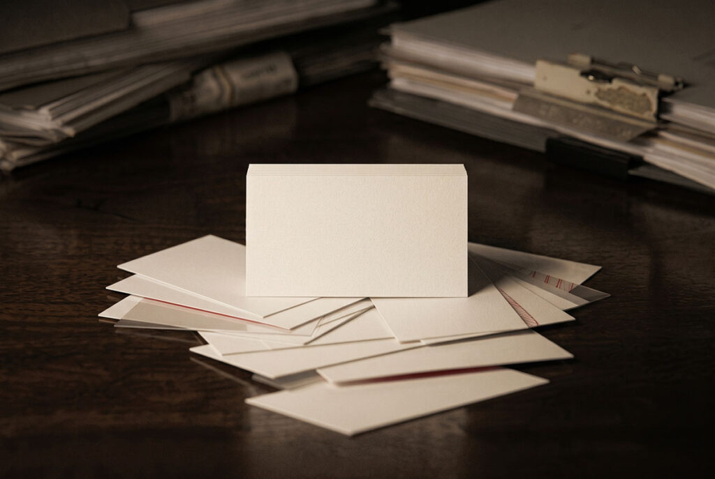 A blank business card with overlapping reflections suggesting fragmented professional identity.