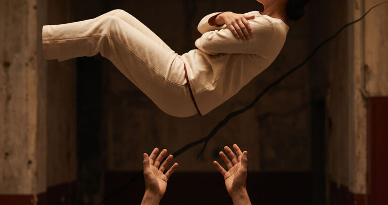 A person falls backward toward absent hands, representing the instant collapse of parasocial trust.