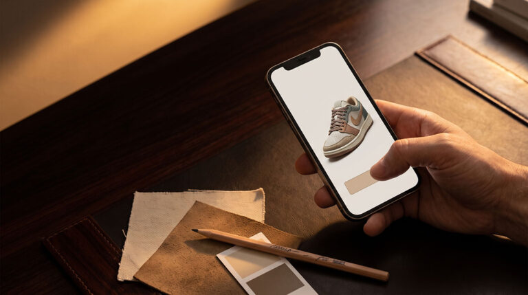 Hand hovering over checkout beside a custom sneaker render, showing how participation creates perceived ownership.