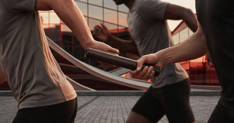 Relay baton passed cleanly between runners, symbolizing customer context preserved across a revenue system.