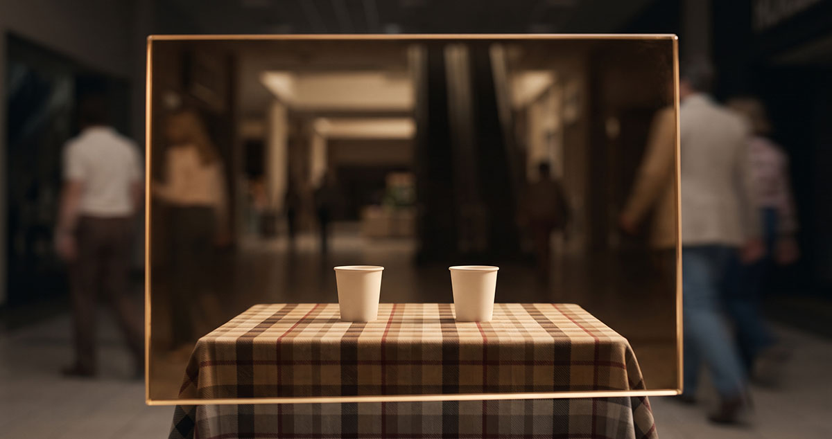 Two unmarked cups seen through amber glass, suggesting the Pepsi Paradox and brand equity as a filter